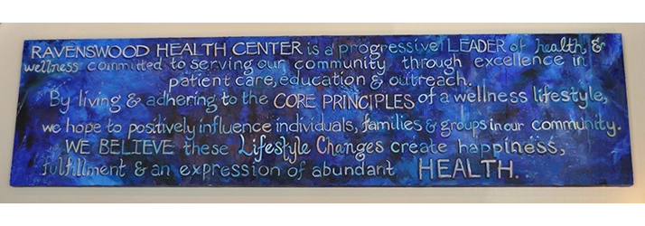 Blue wall plaque displaying Ravenswood Health Center wellness message with handwritten white lettering.